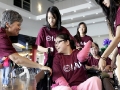 Amy Hao, 16, center, of San Gabriel and who has cerebral palsy, is aided by volunteers from the Foundation for Disabled Youths (FFDY), a grassroots organization in the San Gabriel Valley that serves Chinese American families with disabled children, during an event Saturday, September 24, 2011 with Edison Chinese Connection, from Southern California Edison, at Seasons Place in Industry. (SGVN/Staff Photo by Sarah Reingewirtz/SVCITY)